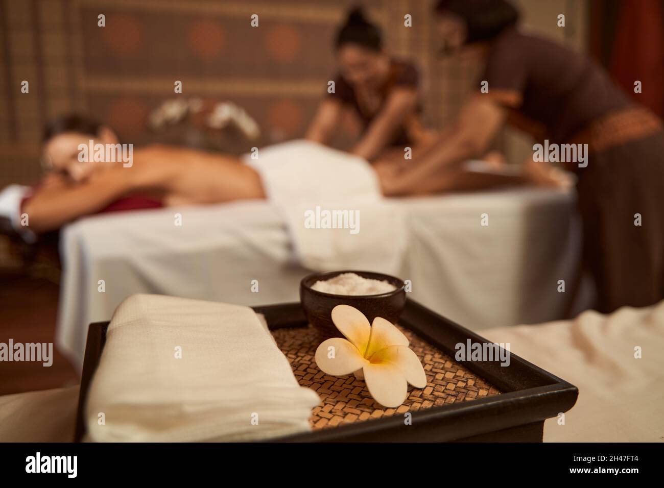 Female Client Getting Four Hand Massage In Wellness Center Stock Photo Female Client Getting Four Hand Massage In Wellness Center Stock Photo